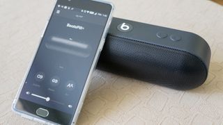 Beats Pill Plus with a phone leaning on it