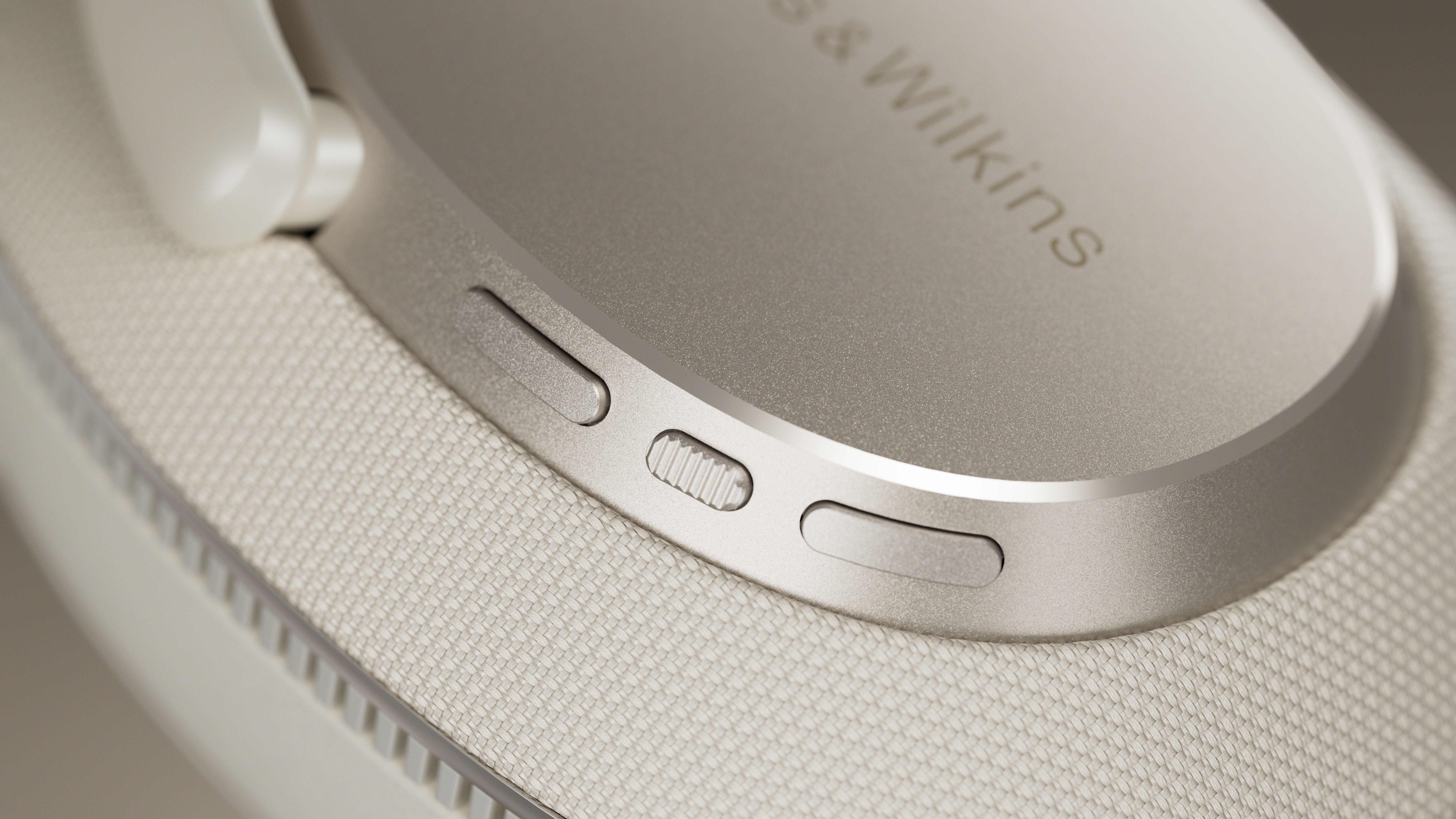 A close up of the controls on the ear cup of a Bowers & Wilkins Px7 S3 headphone