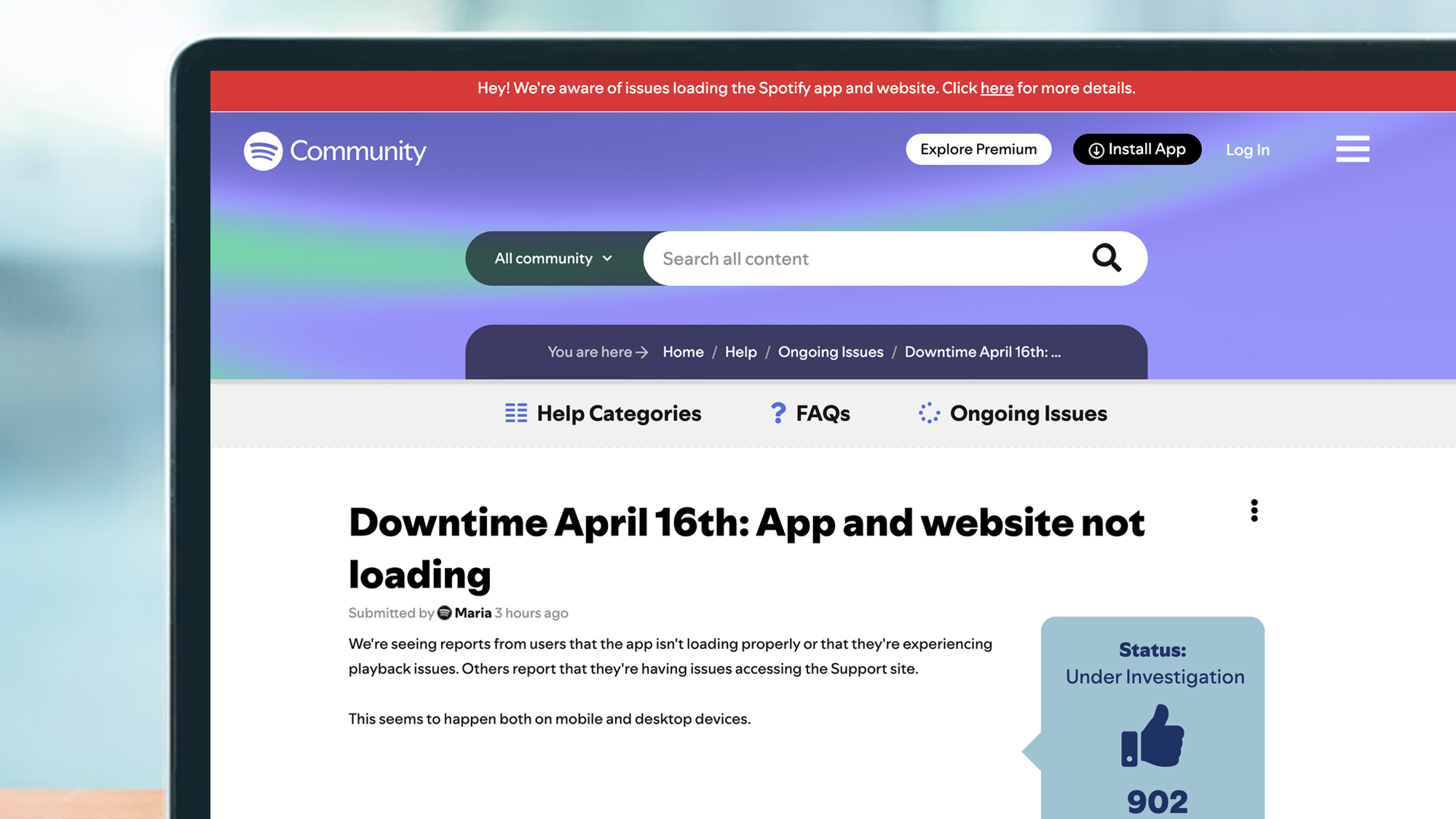 A laptop showing the Spotify Community page during an outage