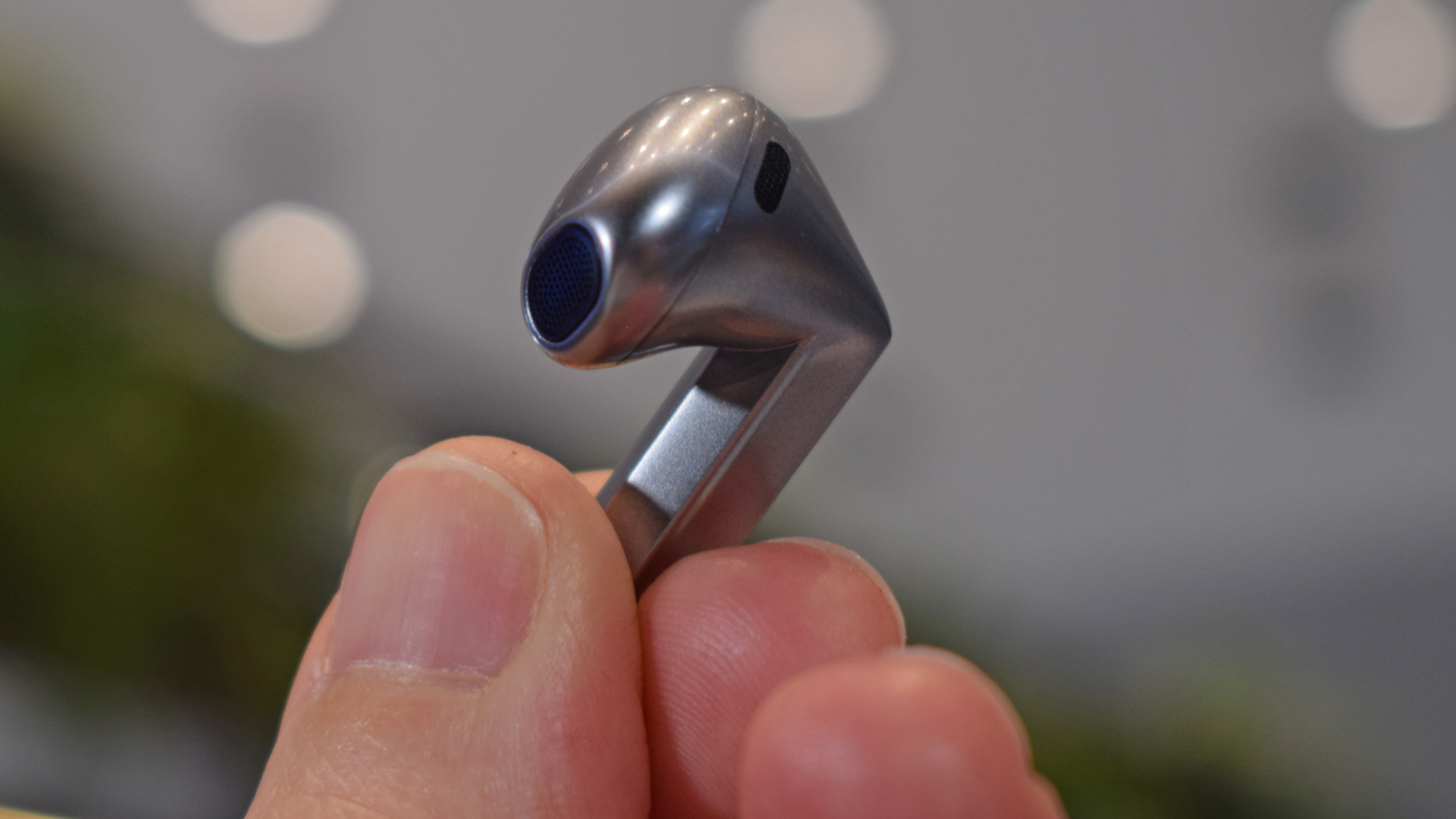 Samsung Galaxy Buds 3 Pro held in a hand, showing the speaker