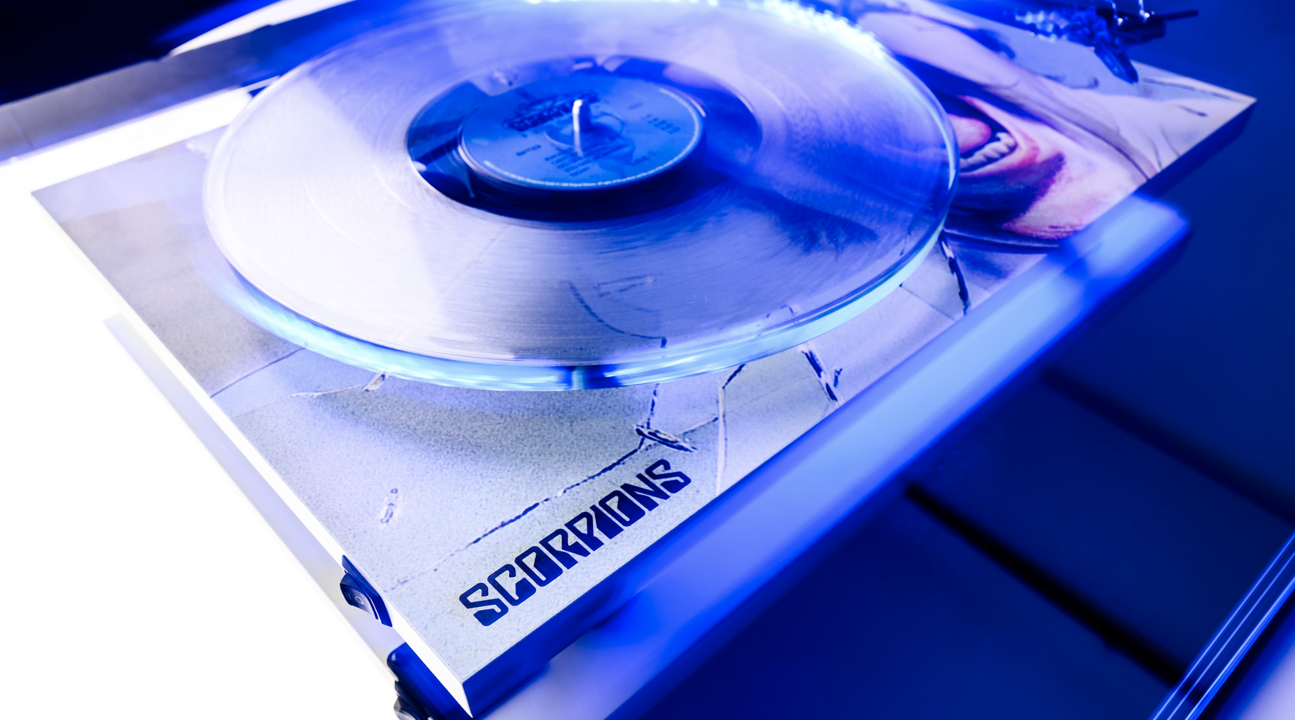 Pro-Ject's Scorpions themed turntable under a blue light, showing the band's stylised name in the left corner of the plinth
